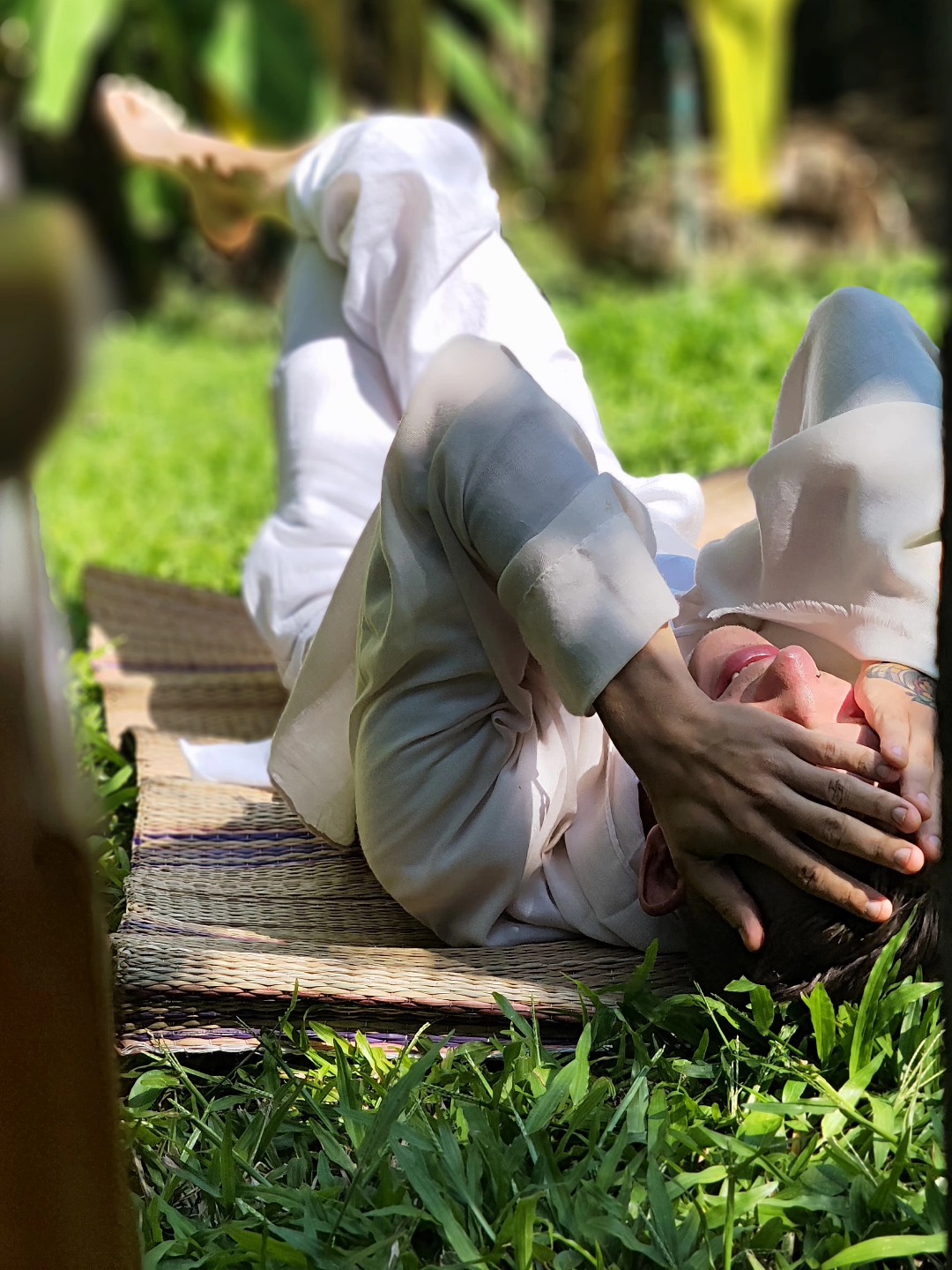 Adam Holman laughing on the grass with friends